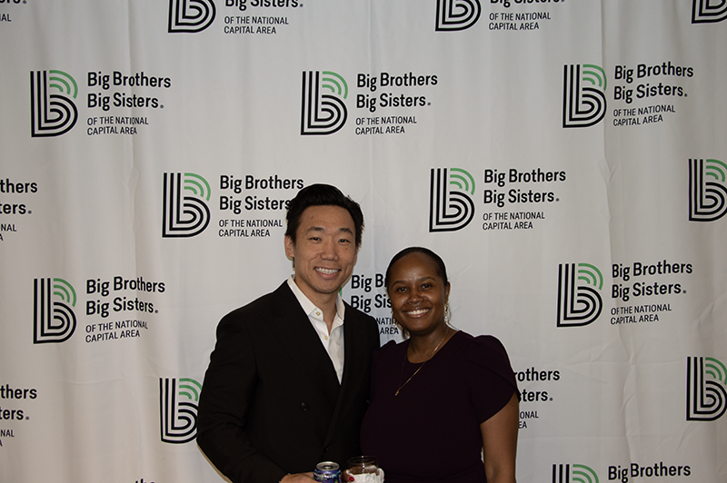 a professional male posing for a photo with a professional female