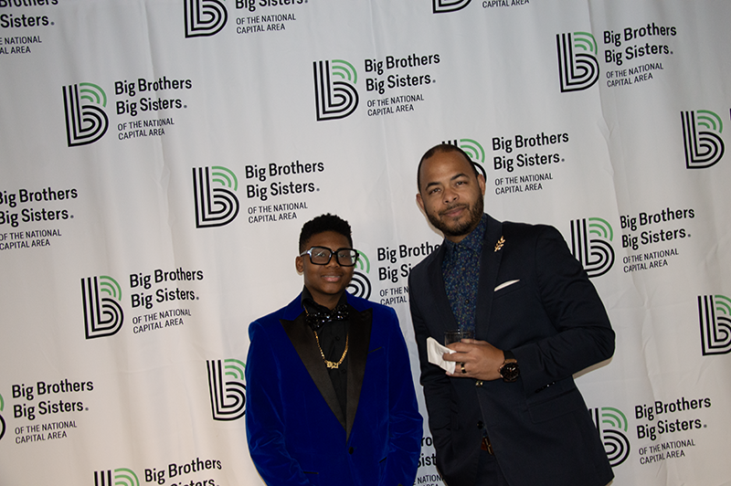 a young male teenager posing for a photo with an adult male