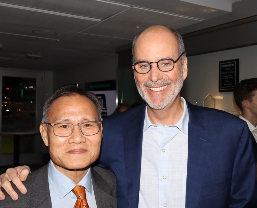 2 adult males smiling for a photo
