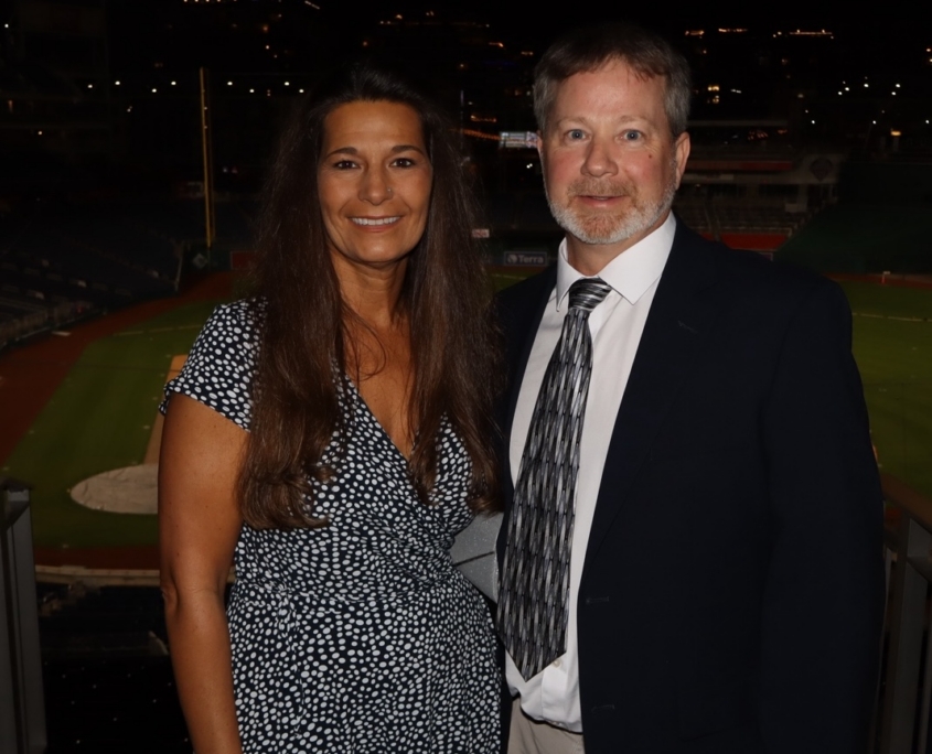 a woman and a man smiling for a photo