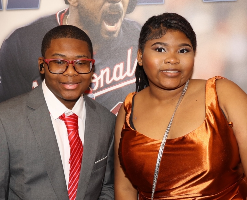 a group photo of two young teens smiling