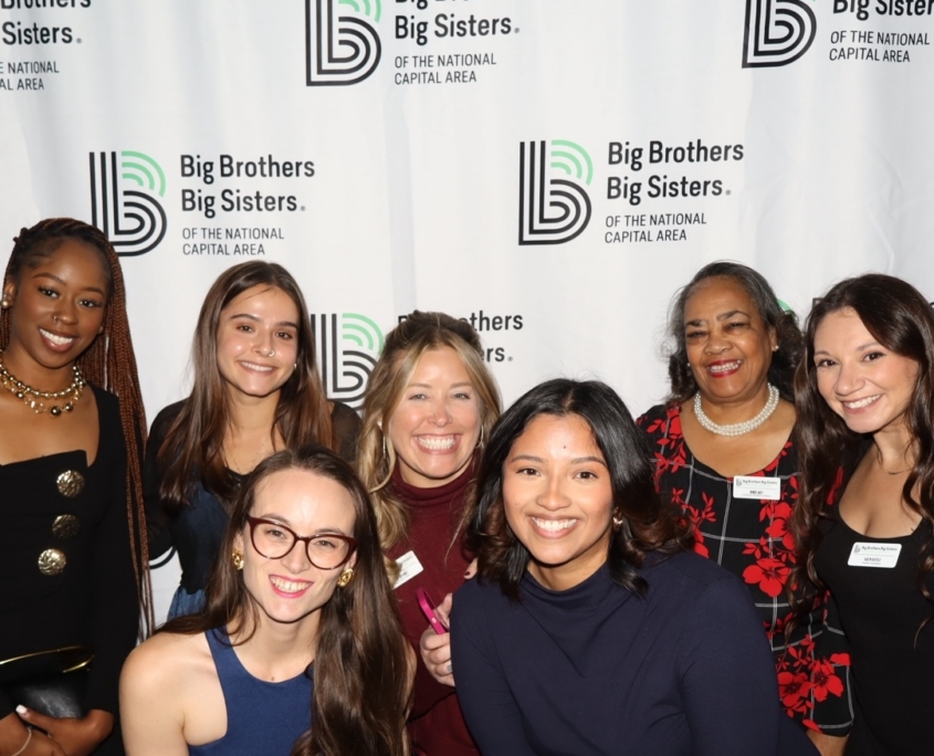 a group photo of women smiling