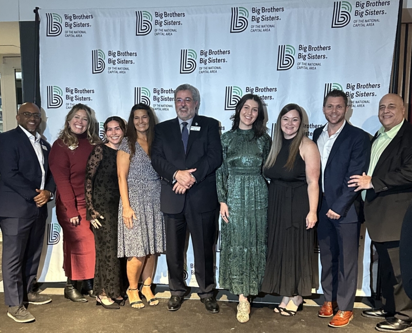 group photo in front of a bbbsnca wall